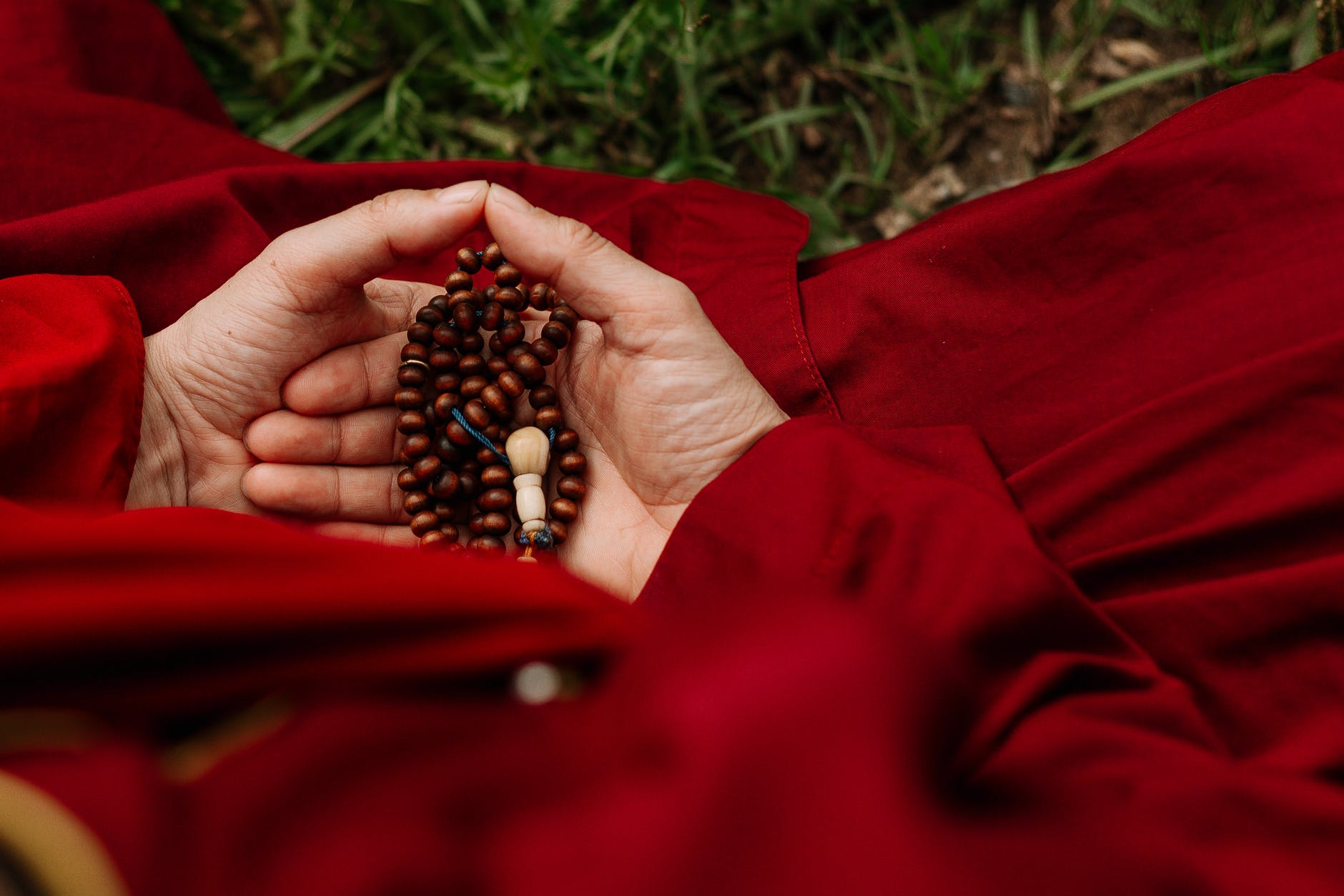 count your blessings person holding red and black beads