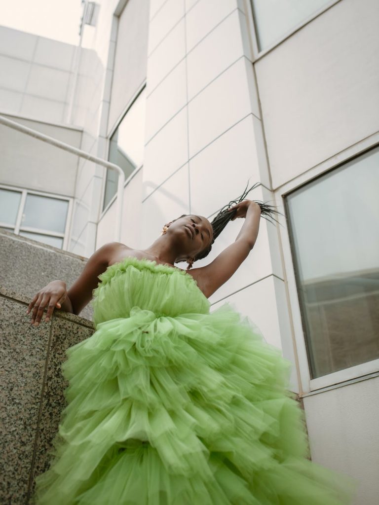 10 Unisex Colours You Can Wear 11 woman in green tulle dress standing next to office building 10 Unisex Colours You Can Wear