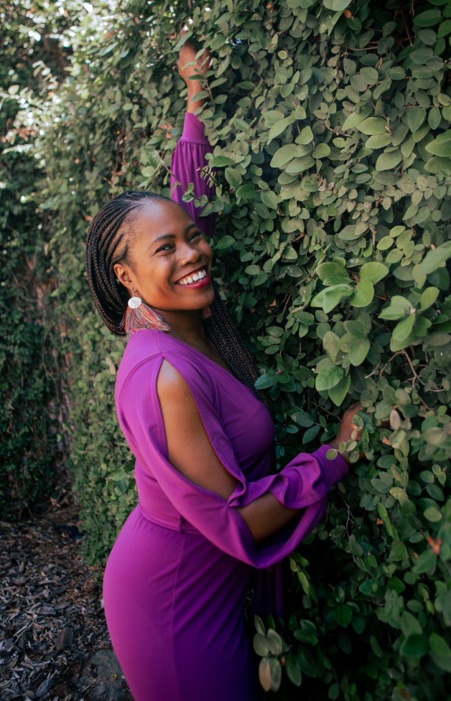 10 Unisex Colours You Can Wear 17 smiling woman in purple dress in garden 10 Unisex Colours You Can Wear