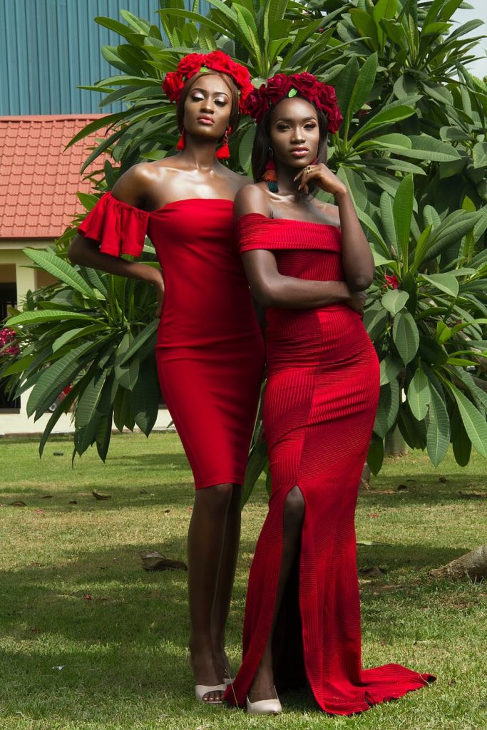 10 Unisex Colours You Can Wear 5 photo of two beautiful women in red dresses and red flower crowns posing in front of green leafed tree 10 Unisex Colours You Can Wear