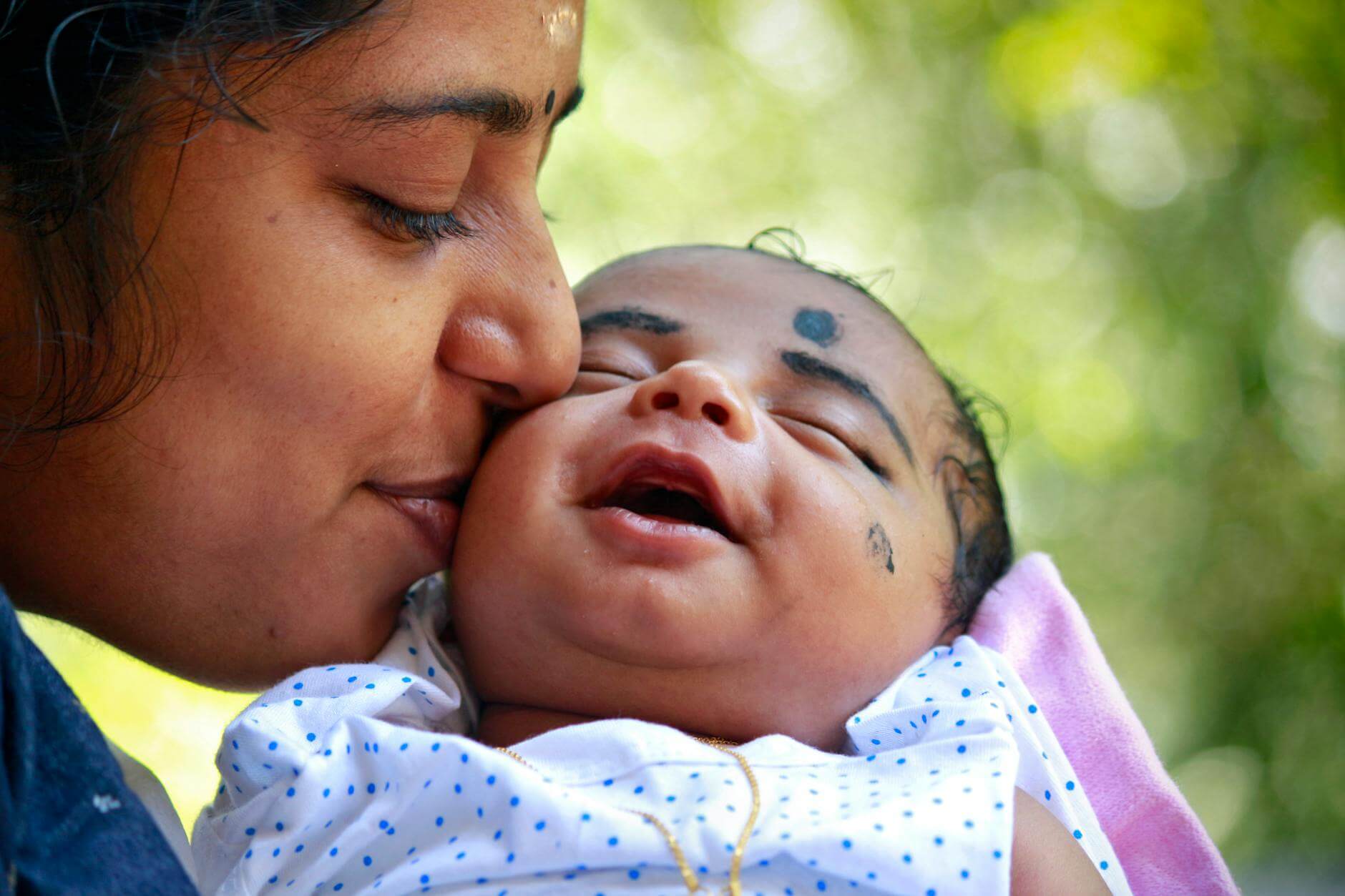 close up photo of mother kissing her baby Best Birthday Gift for Your Mother